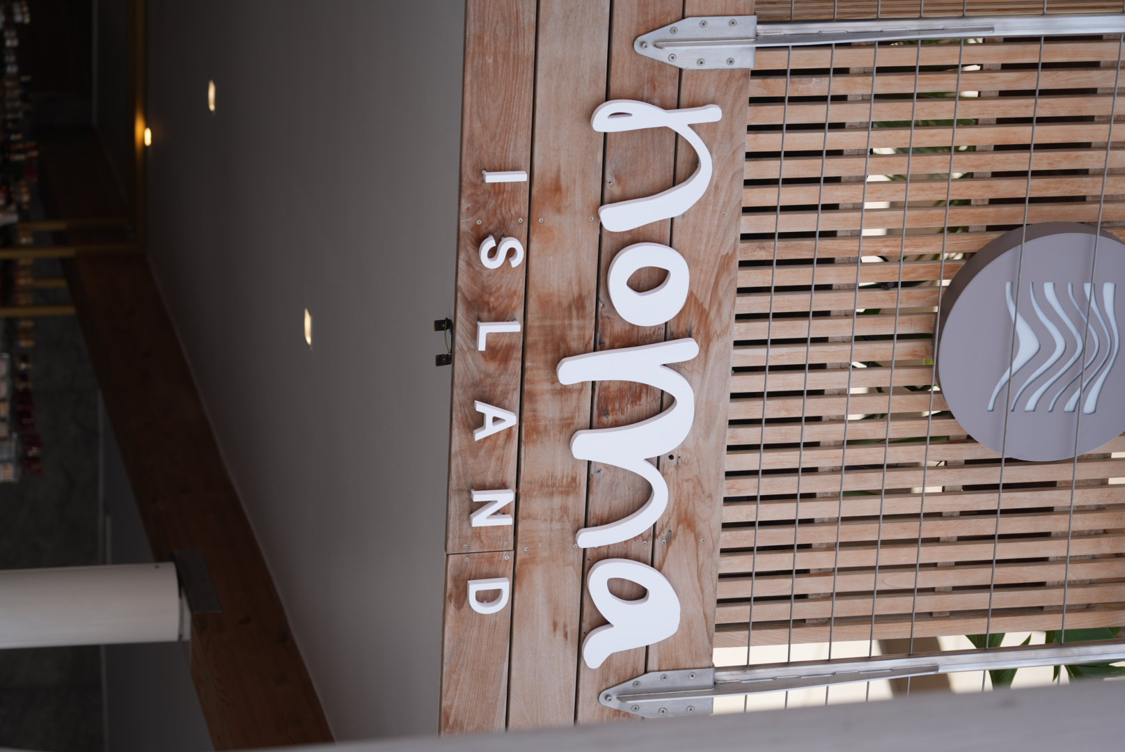 Noma Island logo sign on a wooden slatted facade