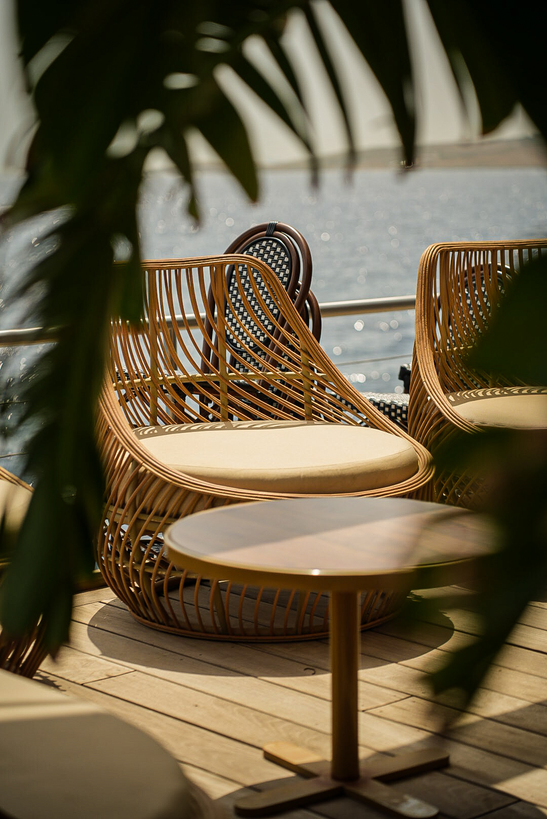 Rattan armchairs facing the sea at Noma Island beach club